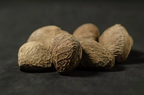 Raw Kluwak Nuts on Dark Background Stock Photos