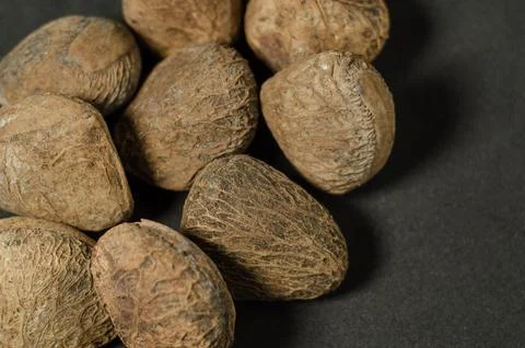 Raw Kluwak Nuts on Dark Background Stock Photos