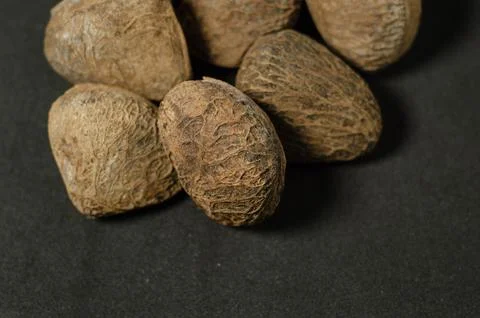 Raw Kluwak Nuts on Dark Background Stock Photos