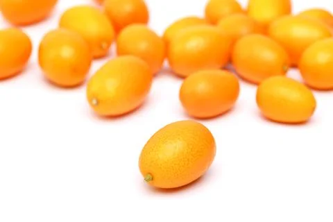 Raw kumquat on a white Stock Photos