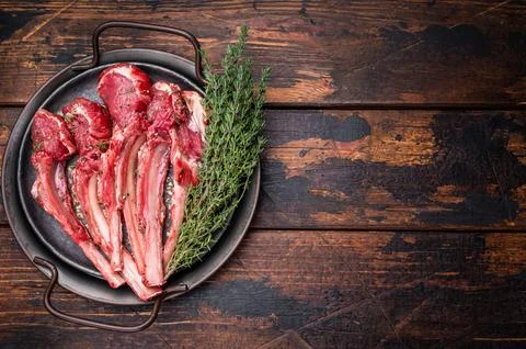 Raw lamb chop cutlets, fresh mutton meat for steaks with herbs. wooden back.. Stock Photos