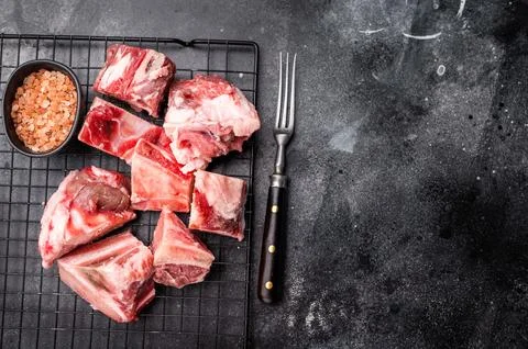 Raw lamb mutton meat and bones for stew or goulash. black background. top vie Stock Photos