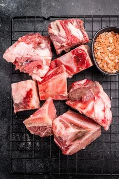 Raw lamb mutton meat and bones for stew or goulash. black background. top vie Stock Photos