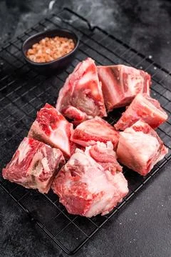 Raw lamb mutton meat and bones for stew or goulash. black background. top vie Stock Photos
