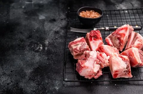 Raw lamb mutton meat and bones for stew or goulash. black background. top vie Stock Photos