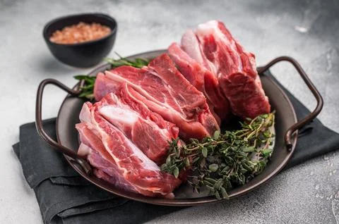 Raw lamb Riblets, fresh mutton meat with rib bone. grey background. top view Stock Photos