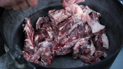 Raw lamb ribs prepared for cooking lying in a cast-iron cauldron. HD 動画素材 73647607