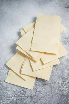 Raw lasagna sheets stack on a kitchen table. White background. Top view 스톡 사진
