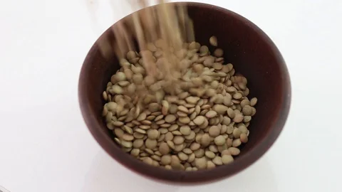 Raw lentil falling into the bowl. Stock Footage 129248938