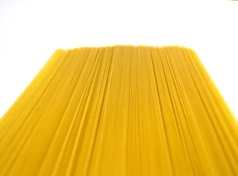 Raw long yellow spaghetti with perspective isolated on white Stock Photos