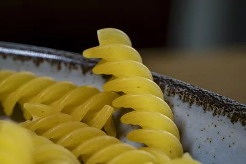 Raw macaroni pasta on table Stock Photos