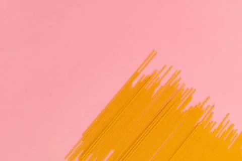 Raw macaroni on pink background Stock Photos