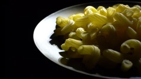 Raw macaroni in rotation. Elbow macaroni. Macaroni rigati close up. Stock Footage 101660816