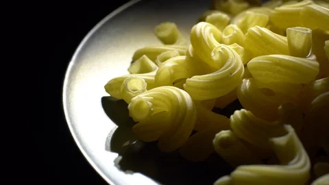 Raw macaroni in rotation. Elbow macaroni. Macaroni rigati close up. Stock Footage 101666442