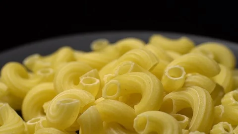 Raw macaroni in rotation. Elbow macaroni. Macaroni rigati close up. Stock Footage 101666544