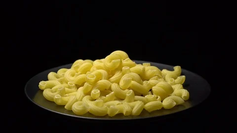 Raw macaroni in rotation. Elbow macaroni. Macaroni rigati close up. Stock Footage 101666642
