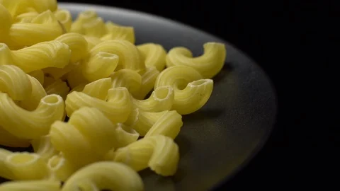 Raw macaroni in rotation. Elbow macaroni. Macaroni rigati close up. Stock Footage 101666752