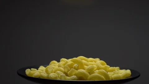 Raw macaroni in rotation. Elbow macaroni. Macaroni rigati close up. Stock Footage 101667022