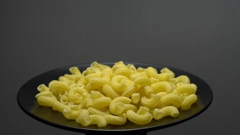 Raw macaroni in rotation. Elbow macaroni. Macaroni rigati close up. Stock Footage 101667228