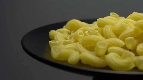 Raw macaroni in rotation. Elbow macaroni. Macaroni rigati close up. Stock Footage 101667257