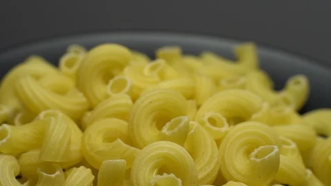 Raw macaroni in rotation. Elbow macaroni. Macaroni rigati close up. Stock Footage 101667572