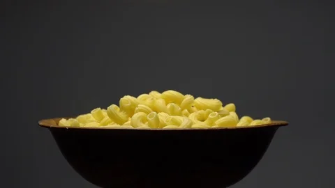 Raw macaroni in rotation. Elbow macaroni. Macaroni rigati close up. Stock Footage 101705483