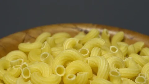 Raw macaroni in rotation. Elbow macaroni. Macaroni rigati close up. Stock Footage 101706207