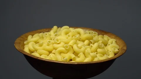 Raw macaroni in rotation. Elbow macaroni. Macaroni rigati close up. Stock Footage 101706262