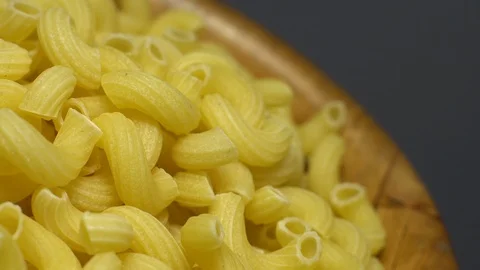 Raw macaroni in rotation. Elbow macaroni. Macaroni rigati close up. Stock Footage 101706334