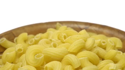 Raw macaroni in rotation. Elbow macaroni.  Macaroni rigati close up. Stock Footage 101706477