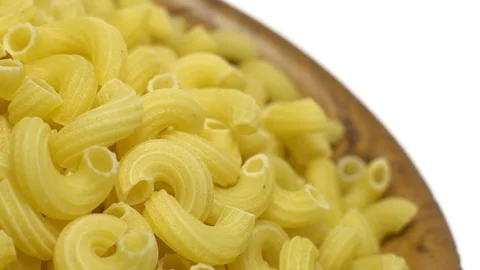 Raw macaroni in rotation. Elbow macaroni.  Macaroni rigati close up. Stock Footage 101706493