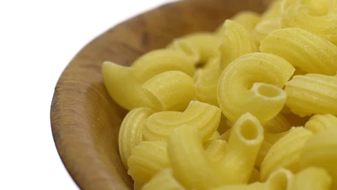Raw macaroni in rotation. Elbow macaroni.  Macaroni rigati close up. Stock Footage 101706621