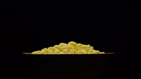 Raw macaroni in rotation. Elbow macaroni. Macaroni rigati close up. Stock Footage 101706893