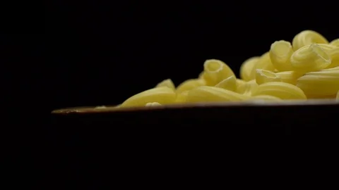 Raw macaroni in rotation. Elbow macaroni. Macaroni rigati close up. Stock Footage 101706899