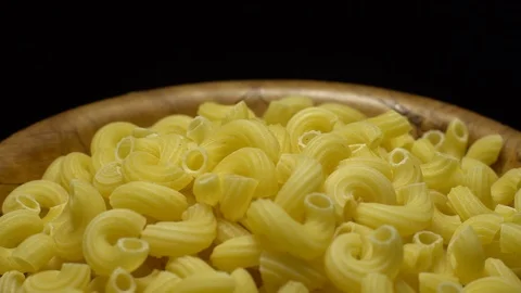 Raw macaroni in rotation. Elbow macaroni. Macaroni rigati close up. Stock Footage 101706908