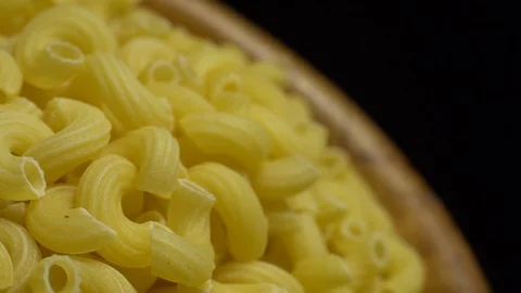 Raw macaroni in rotation. Elbow macaroni. Macaroni rigati close up. Stock Footage 101707475