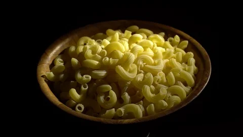 Raw macaroni in rotation. Elbow macaroni. Macaroni rigati close up. Stock Footage 101707559