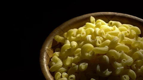 Raw macaroni in rotation. Elbow macaroni. Macaroni rigati close up. Stock Footage 101707869