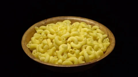 Raw macaroni in rotation. Elbow macaroni. Macaroni rigati close up. Stock Footage 101708068