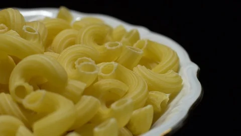 Raw macaroni in rotation. Elbow macaroni. Macaroni rigati close up. Stock Footage 101745039