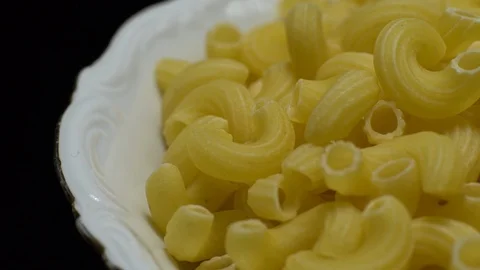 Raw macaroni in rotation. Elbow macaroni. Macaroni rigati close up. Stock Footage 101745102