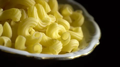 Raw macaroni in rotation. Elbow macaroni. Macaroni rigati close up. Stock Footage 101745383