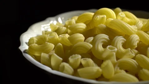 Raw macaroni in rotation. Elbow macaroni. Macaroni rigati close up. Stock Footage 101745593