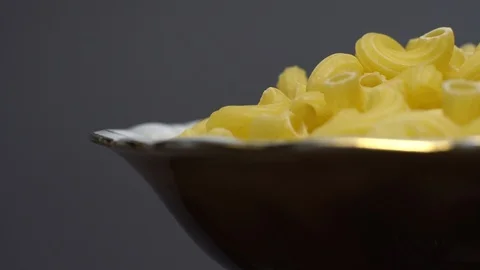 Raw macaroni in rotation. Elbow macaroni. Macaroni rigati close up. Stock Footage 101745983