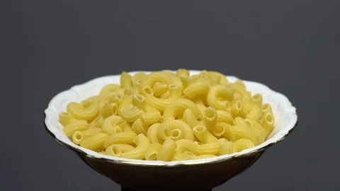 Raw macaroni in rotation. Elbow macaroni. Macaroni rigati close up. Stock Footage 101746062