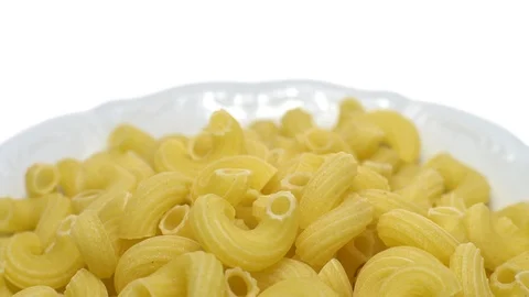 Raw macaroni in rotation. Elbow macaroni.  Macaroni rigati close up. Stock Footage 101746439