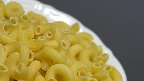 Raw macaroni in rotation. Elbow macaroni. Macaroni rigati close up. Stock Footage 101746764
