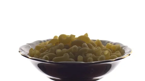 Raw macaroni in rotation. Elbow macaroni.  Macaroni rigati close up. 動画素材 101747024