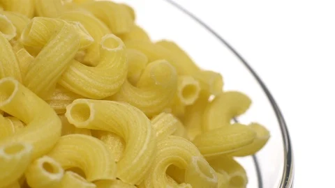 Raw macaroni in rotation. Elbow macaroni.  Macaroni rigati close up. Stock Footage 101748338