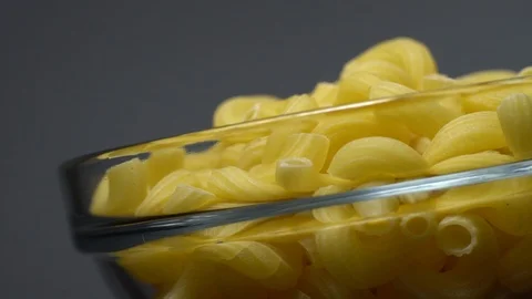 Raw macaroni in rotation. Elbow macaroni. Macaroni rigati close up. Stock Footage 101748714